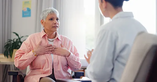 A medical professional consults with an elderly patient